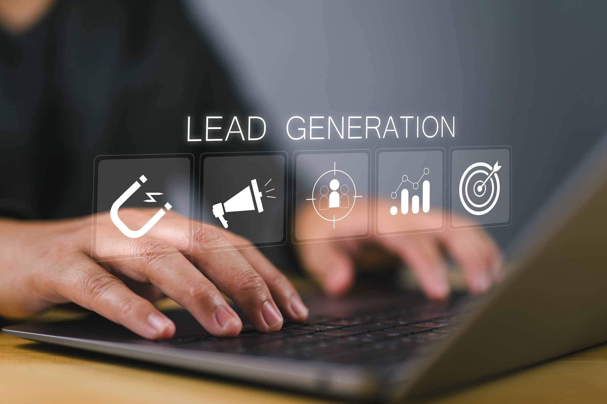 Hands typing with lead generation icons displayed.